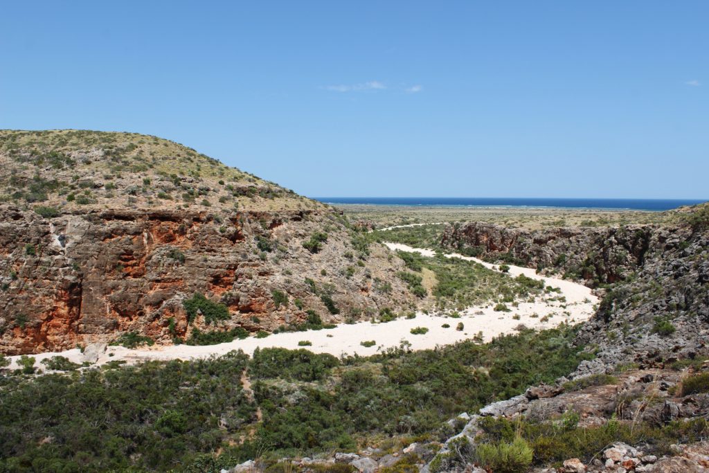 See the dry riverbed trail through red gorges down to the Ningaloo Coast, Australia