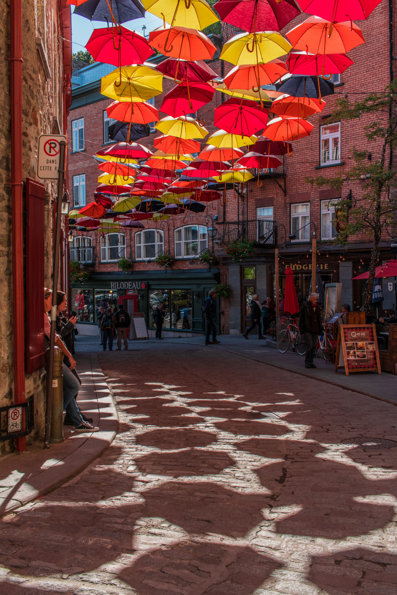 A street lined with colourful umbrellas in Québec, Canada