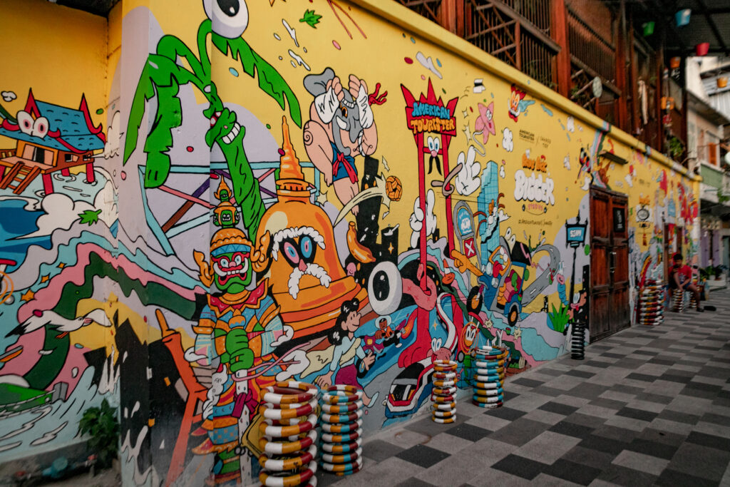 Colourful street art covering the exterior wall of a cafe in Bangkok