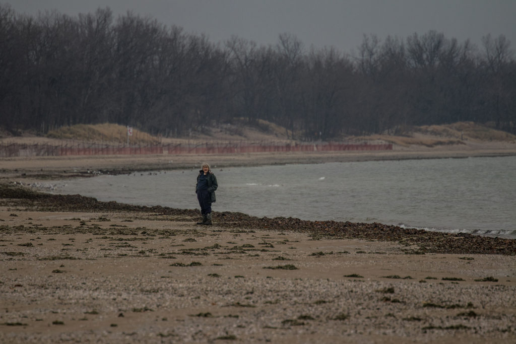 Sue Meech, founder of Sandy Pines Wildlife Centre, walking along the shores of Lake Ontario, Canada
