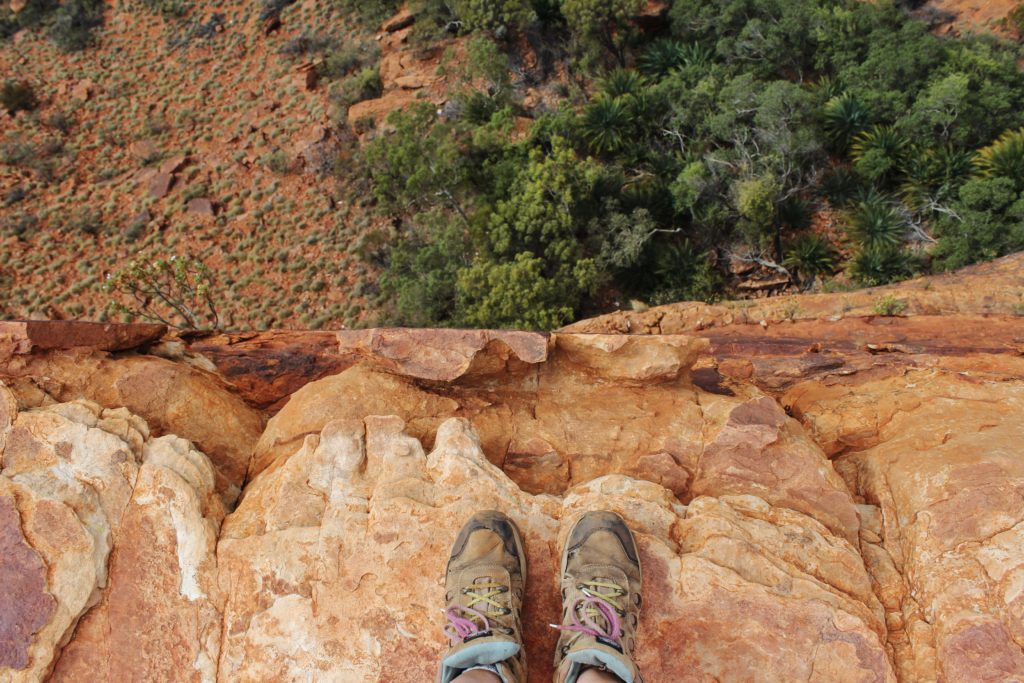 Staring down the 100 foot drop of King's Canyon, Australia