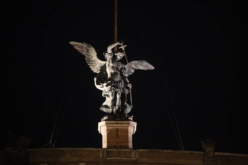 The angel statue above Castel Sant' Angelo lit up at night in Rome, Italy