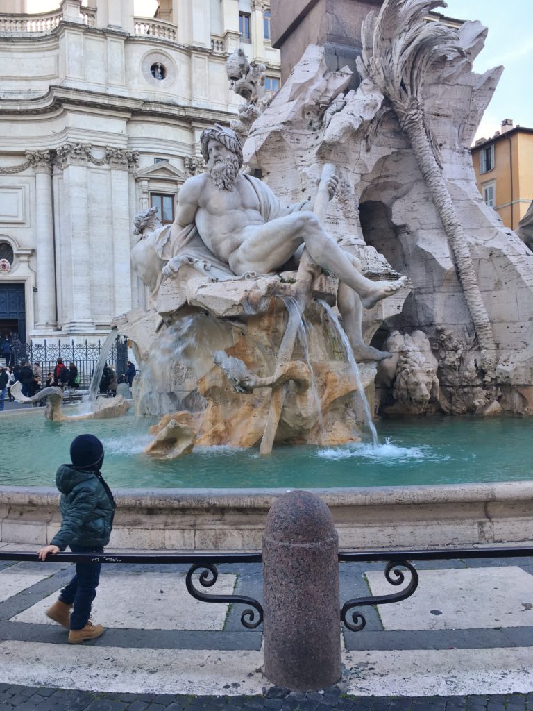 A child watches the fountain in Piazza Navona, Rome, Italy