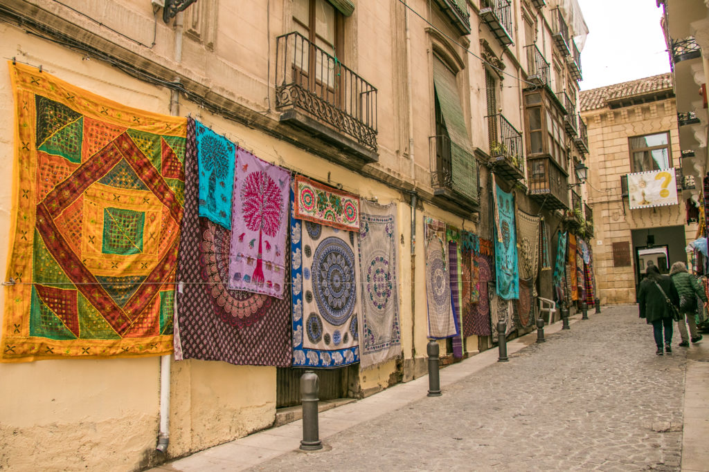 Colourful rugs for sale in the Albaicín district of Granada, Spain
