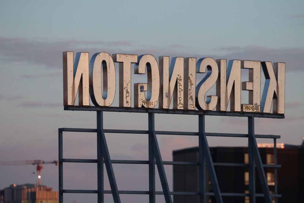 The Kensington sign lit by the glow of sunset, Toronto, Canada