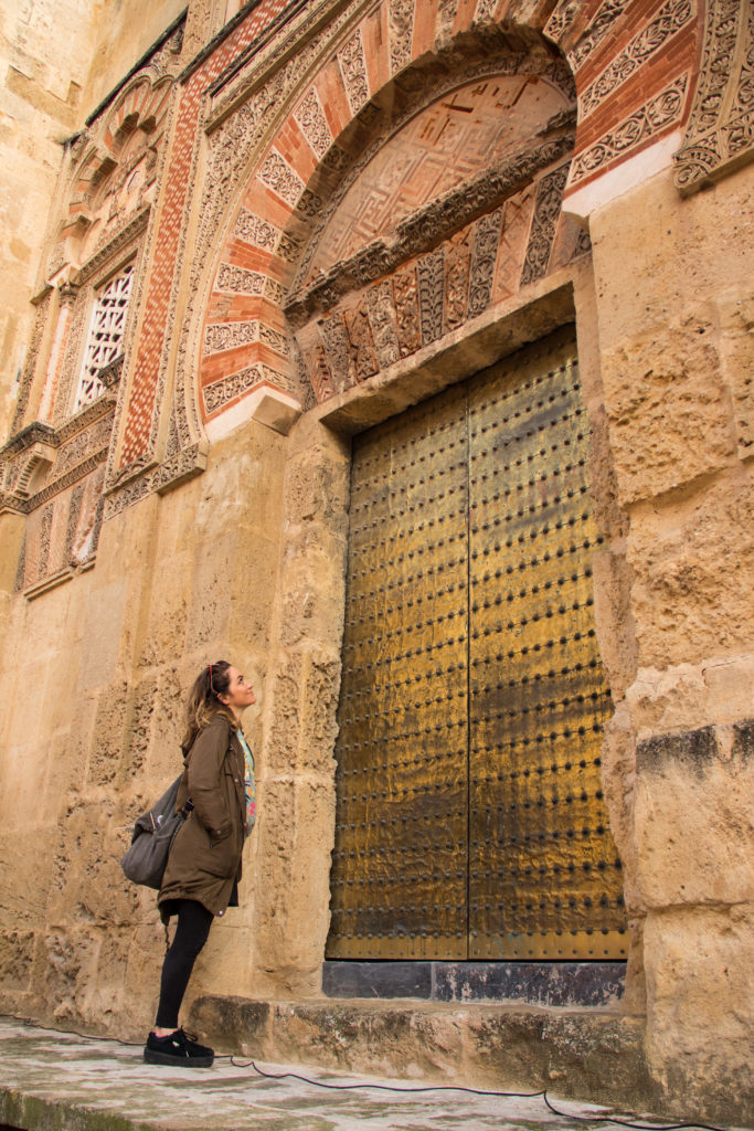 Standing by one of the external doors of Córdoba's Mezquita, Spain