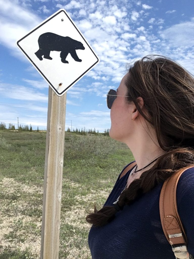 Standing in front of a polar bear warning sign in Churchill, Canada