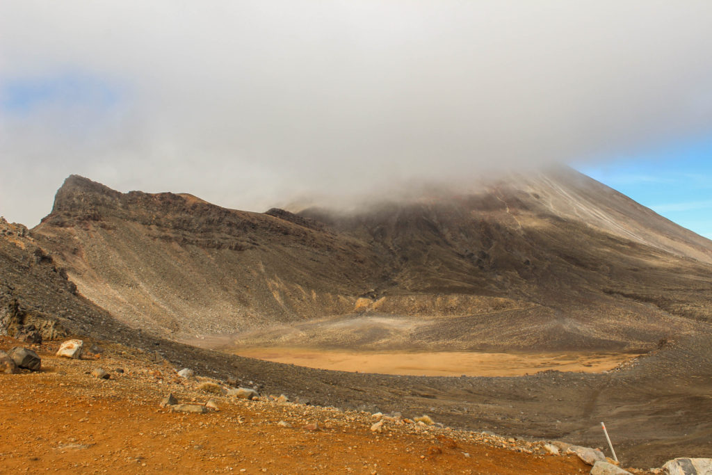 Fog rolls in across a vast volcanic crater in Tongariro National Park
