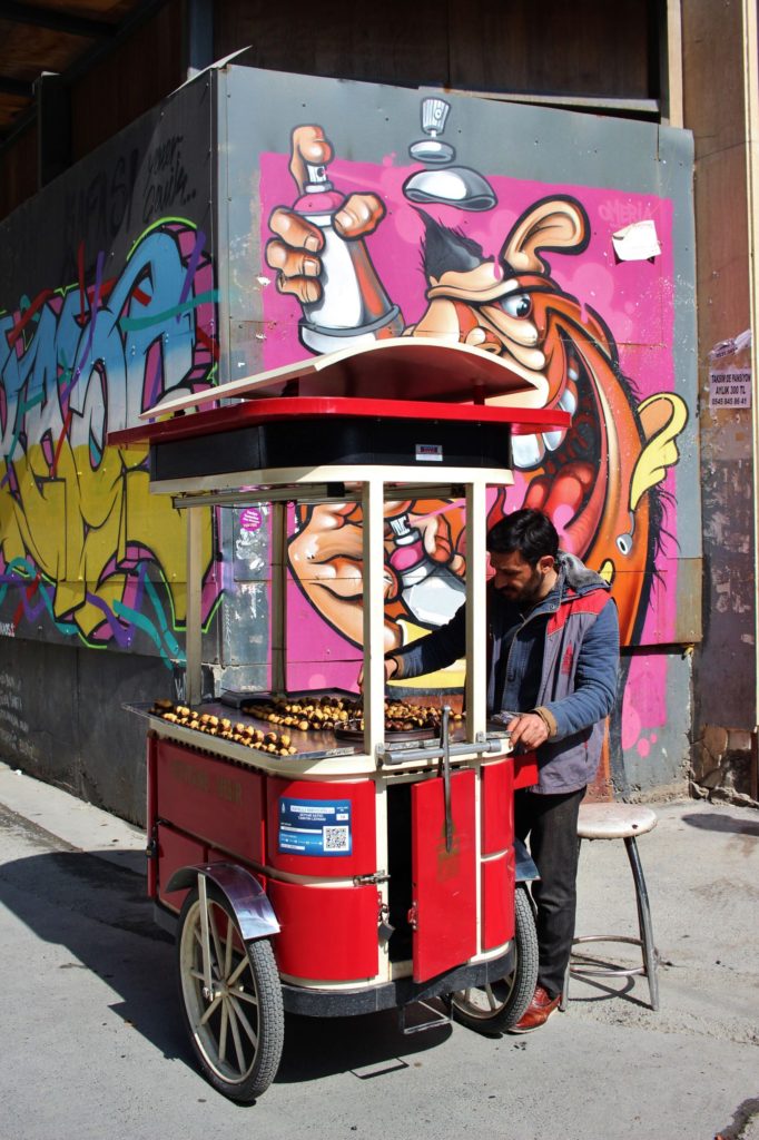 A street vendor with roasted chestnuts on Istanbul's Istiklal Avenue, Turkey