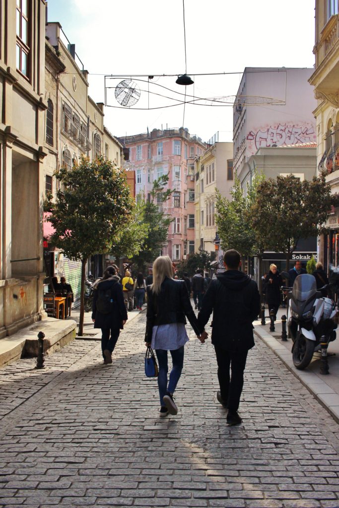 A couple strolls along the cobbled Istiklal Avenue in Istanbul, Turkey