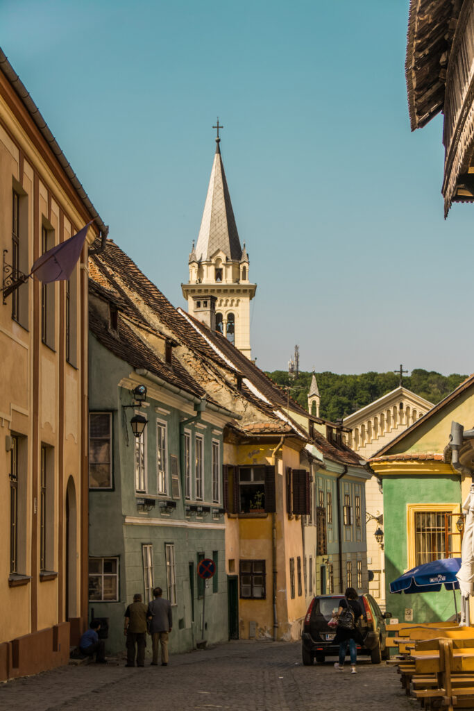 Medieval street with colourful houses and a church spire