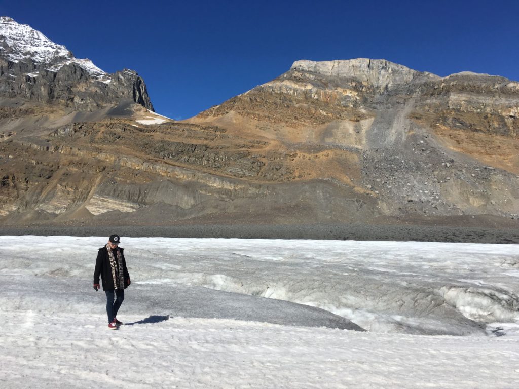 Walking on the Athabasca Glacier with the mountains behind, Canada