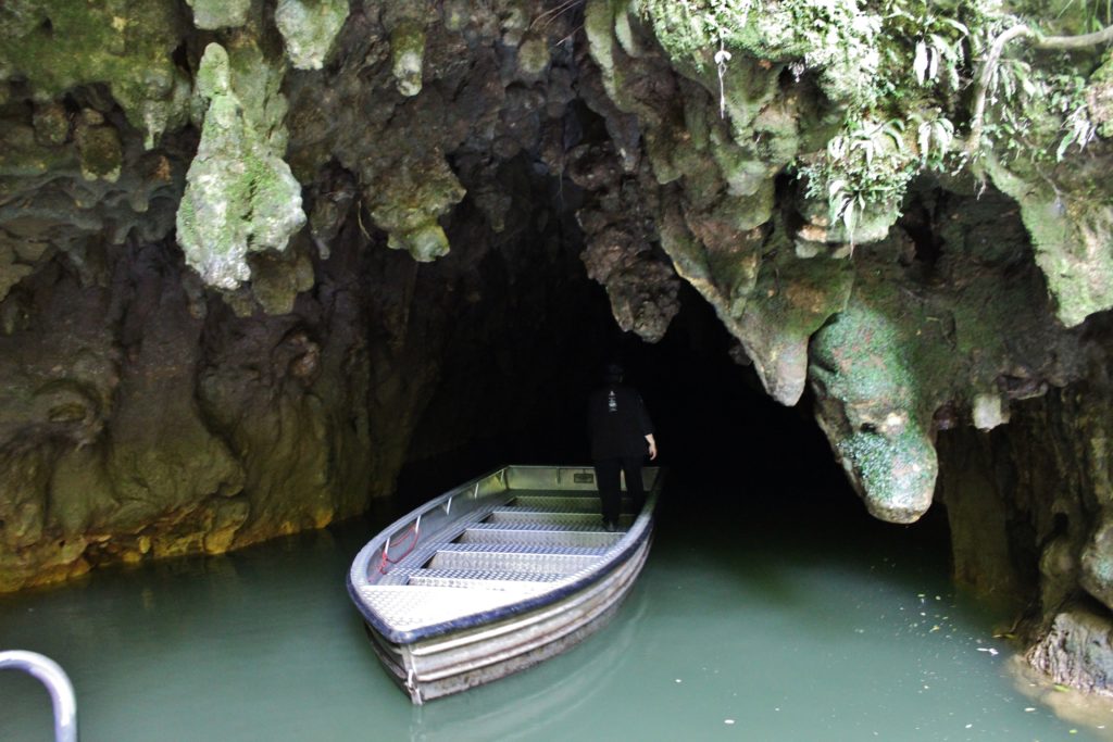 A boat exiting from the Waitomo Glowworm Caves, one of the best New Zealand destinations