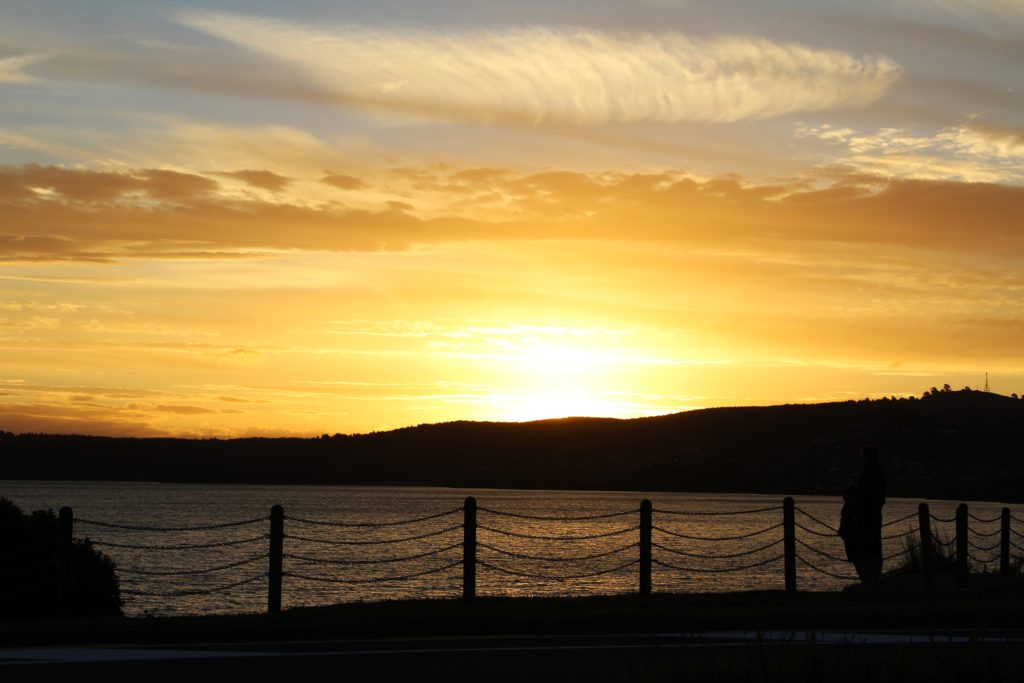 A golden sunset over Lake Taupo, one of the top New Zealand destinations