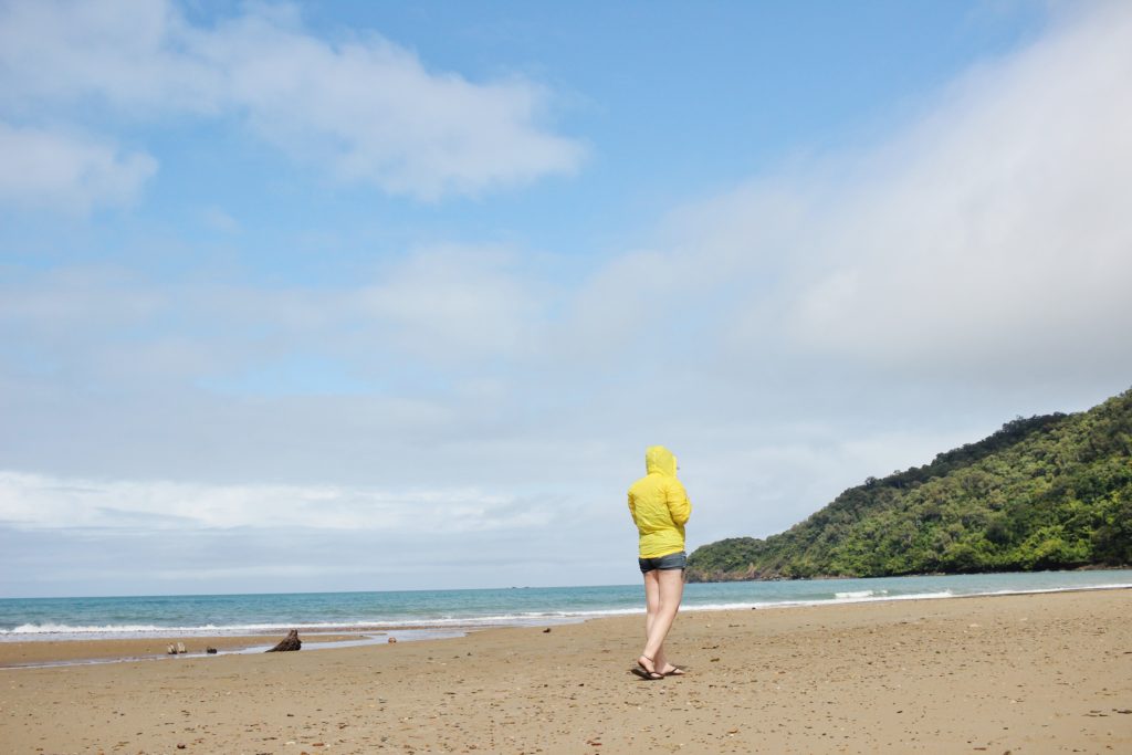 Walking in the rain across the beach at Cape Tribulation, Queensland