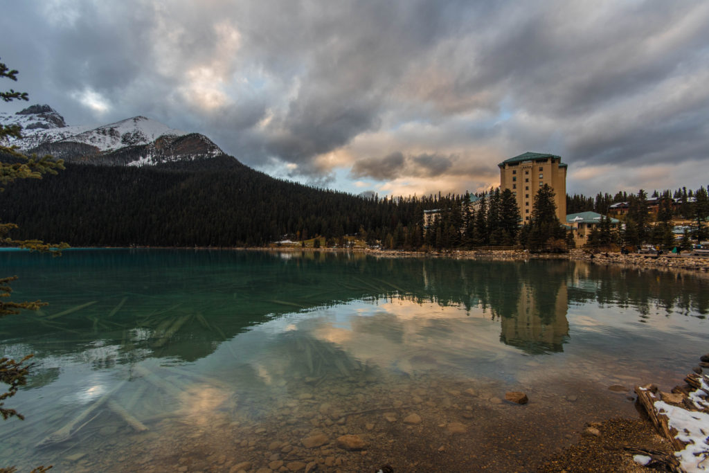 The Fairmont Chateau Lake Louise beside the lake at sunset
