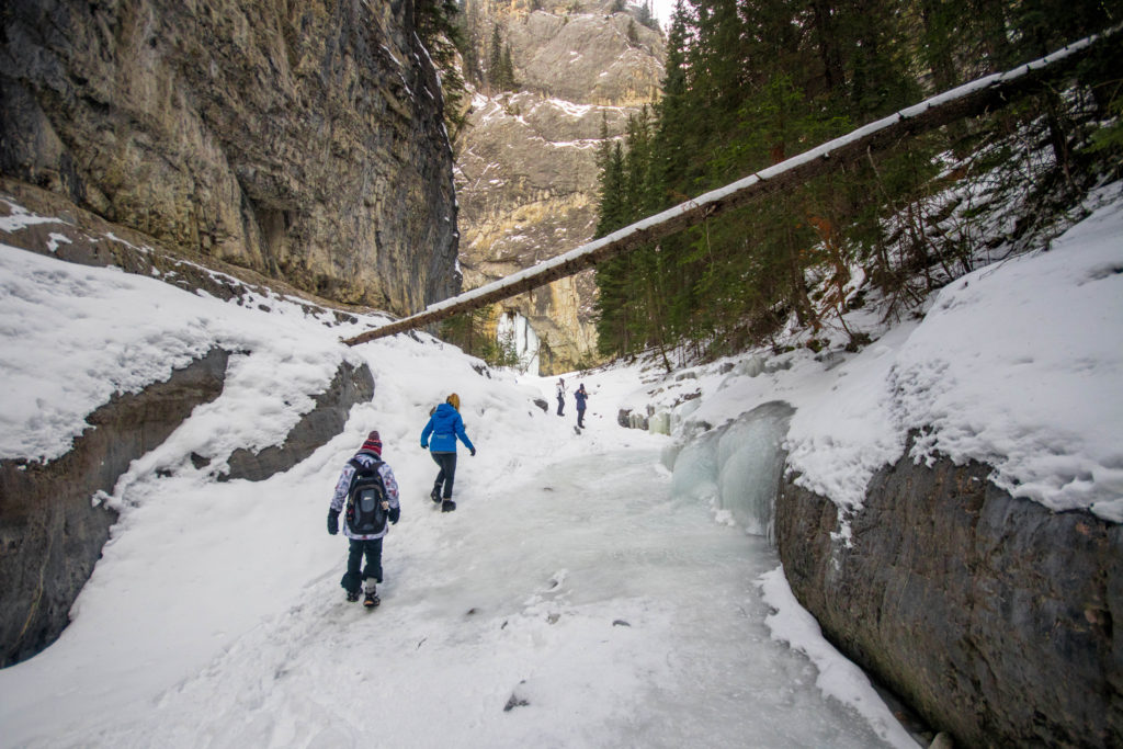 Walking on a frozen river in Grotto Canyon, near Banff, Canada