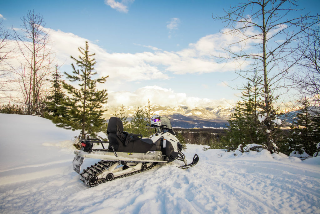 A snowmobile overlooking a mountain view in BC, Canada