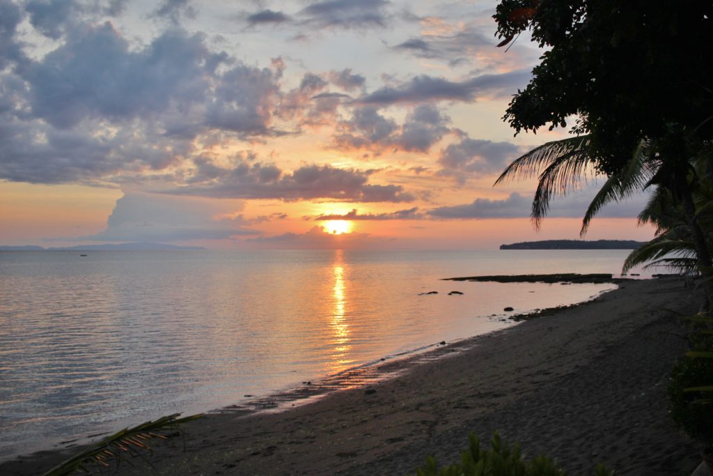 A pink sunset over the ocean at Donsol Bay in the Philippines