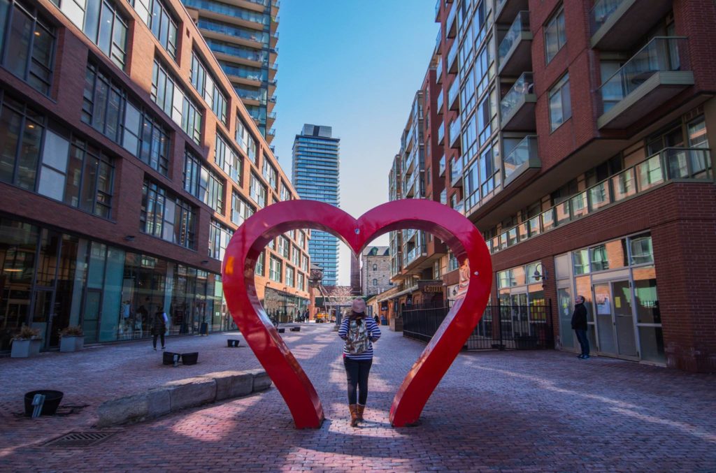 The Distillery District is one of the best photo spots in Toronto because it has many art installations, like this heart-shaped arch