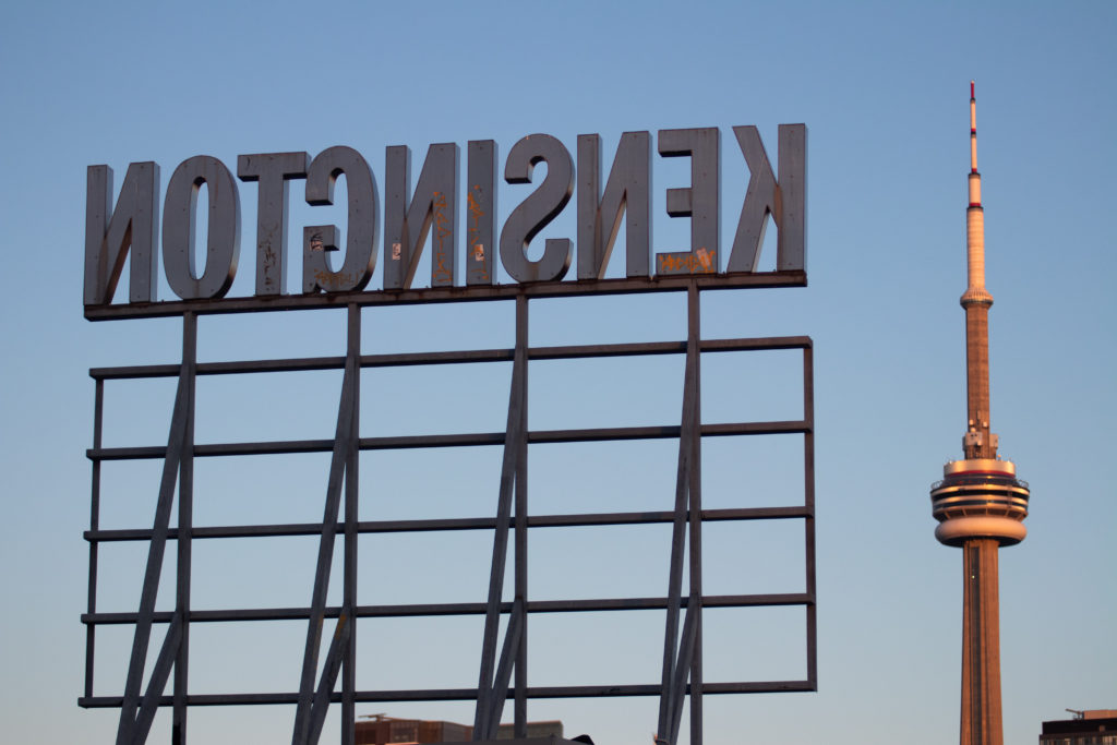 The large Kensington Sign from behind, with the CN Tower in the background