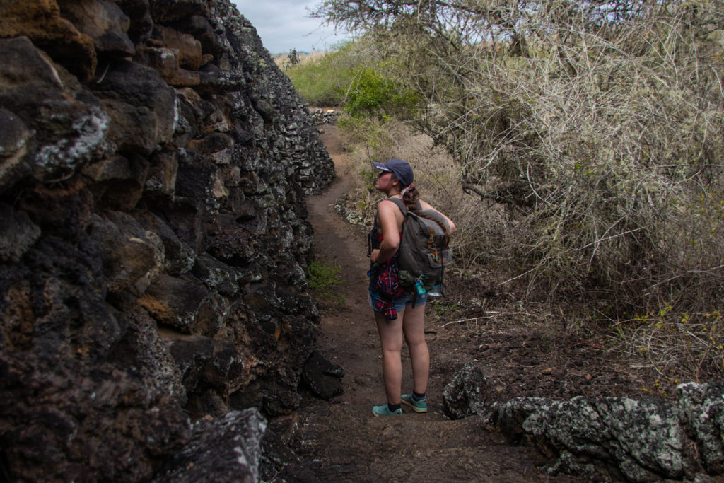 Standing on the steps next to the Wall of Tears, an important monument in the Galapagos