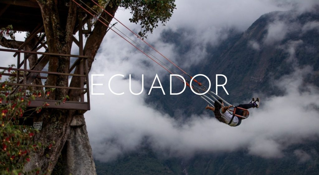 Two weeks in Ecuador - 2 epic itineraries. A person swings out from beneath a tree house with a cloudy mountain in the background. The Swing at the End of the World in Baños.