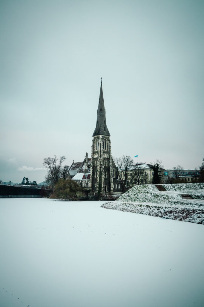 St Alban's Church, with a snow-covered frozen river in front.