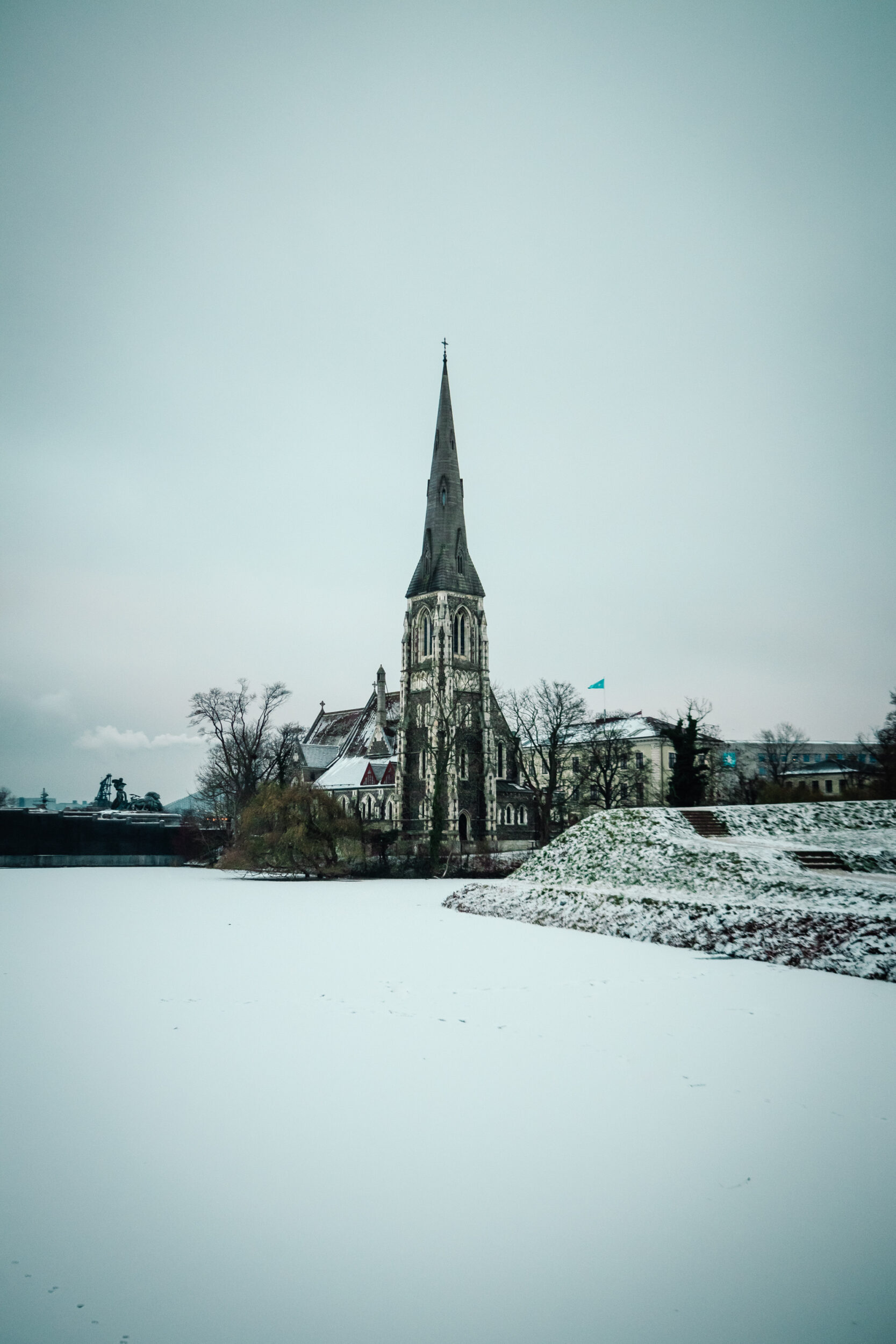 St Alban's Church, with a snow-covered frozen river in front.