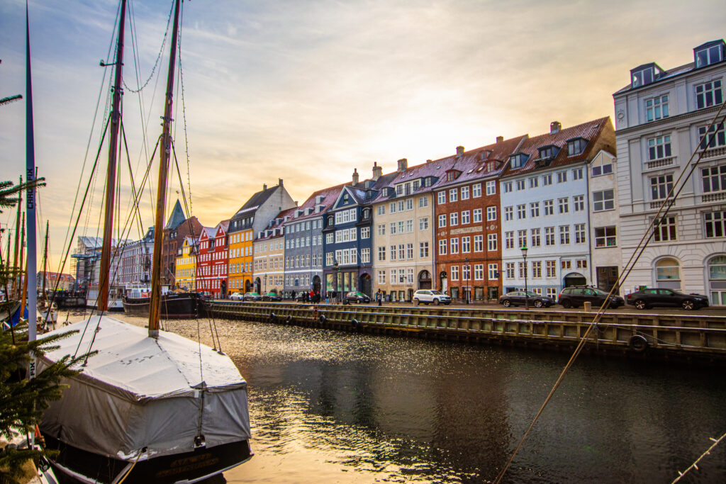 Golden hour over the western houses of Nyhavn, one of the best photo spots in Copenhagen, Denmark