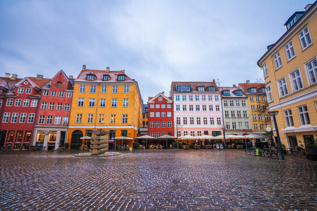 A square in Copenhagen with beautiful colourful buildings, one of the best photo spots in the city