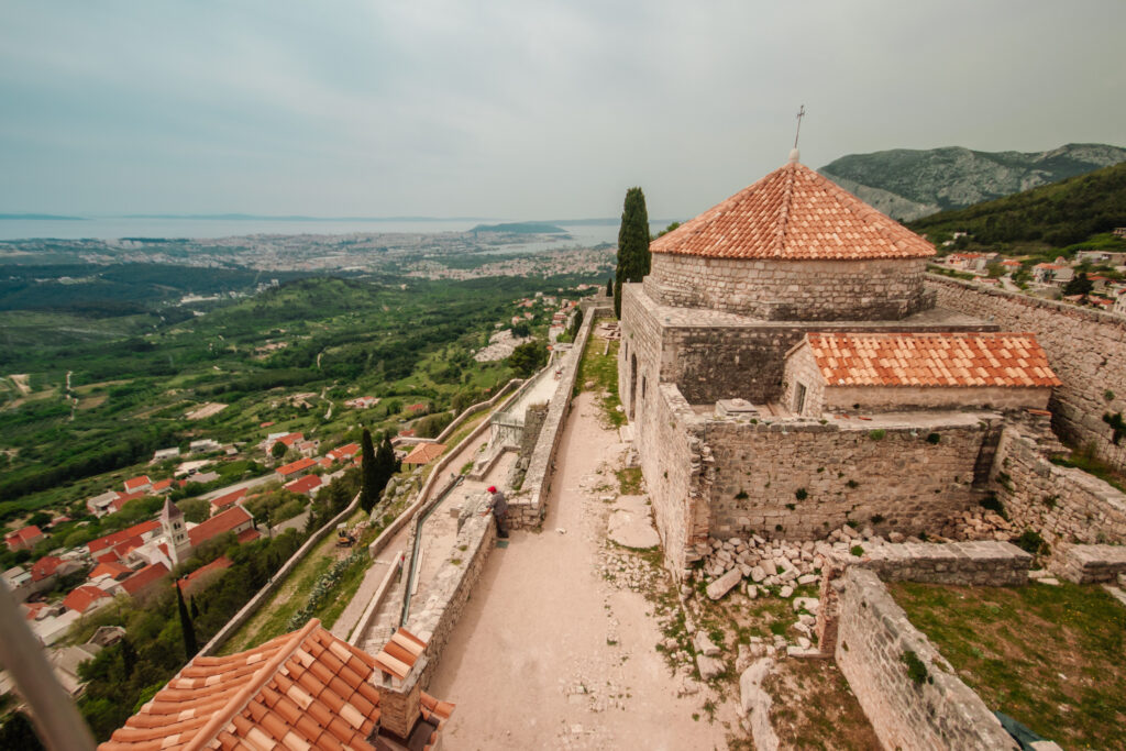 Red rooftops and walls of Klis Fortress, high above Split, Croatia