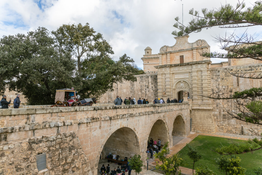 A stone causeway leads to the walled gates of Mdina, the old capital of Malta