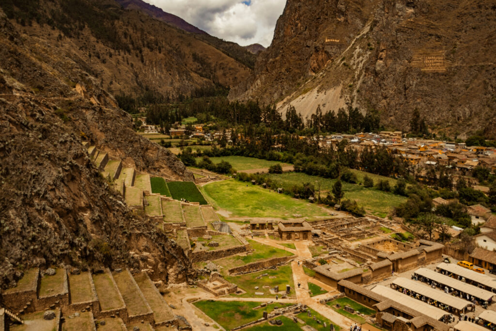 Carved terraces and green fields surrounded by mountains at Ollantaytambo, Peru