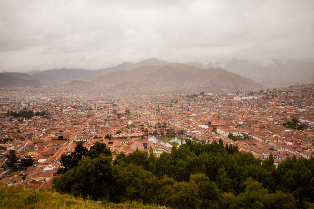 The view across the red roofs of Cusco from the ruins of Saksayhuaman, in the Sacred Valley