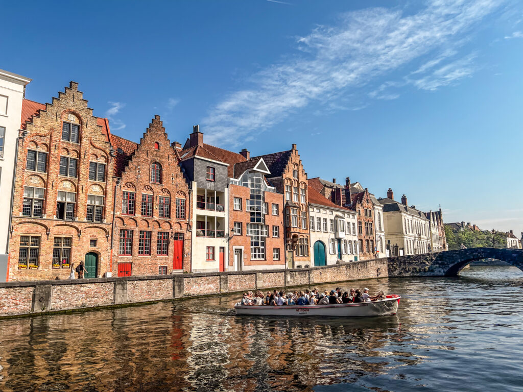 Taking a boat tour around the canals, is one of the best things to do in one day in Bruges
