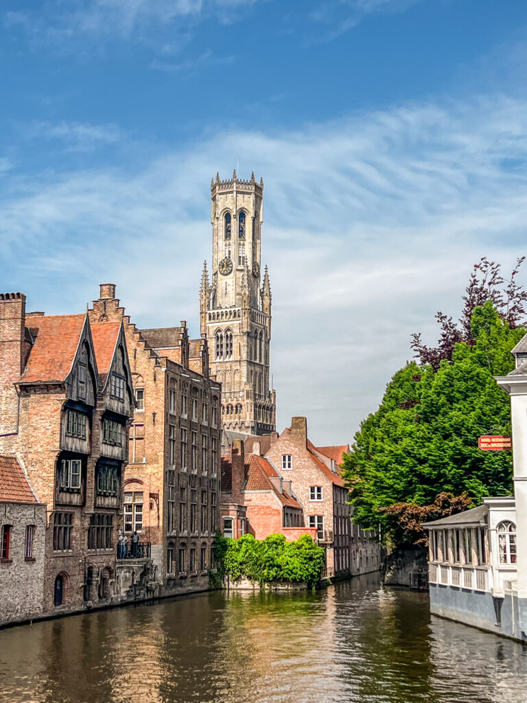 The Belfry rises above the buildings and canals of Bruges
