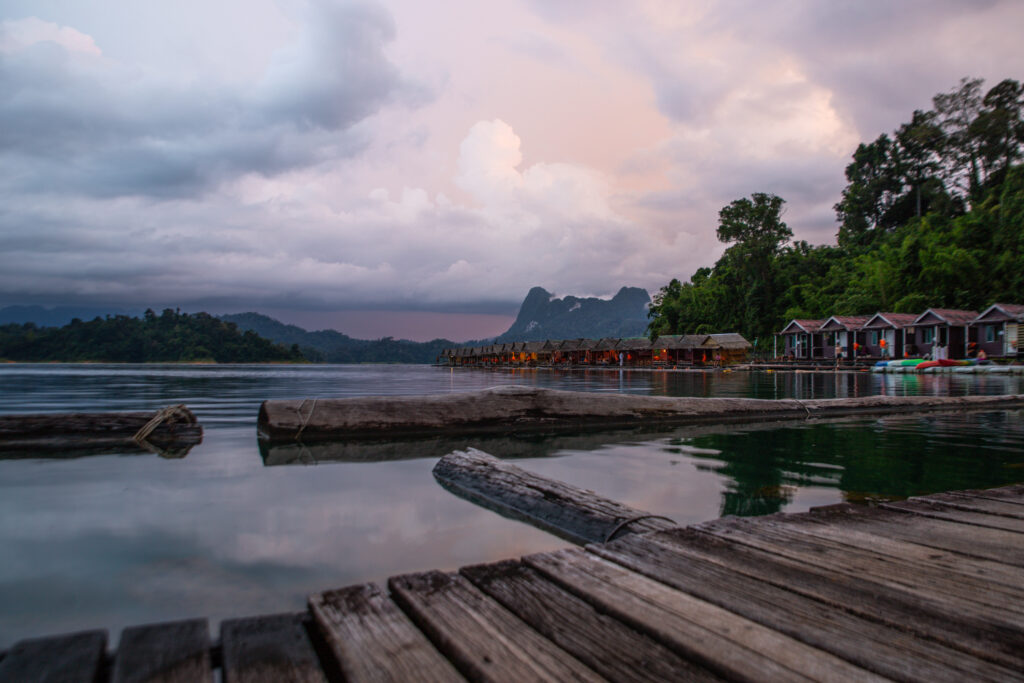 A pastel sunset over a line of floating bungalows on the lake in Khao Sok National Park