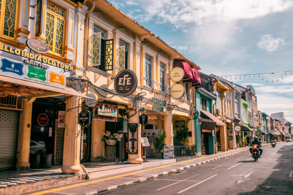 The colourful houses of Phuket's Old Town, with a single motorcyclist