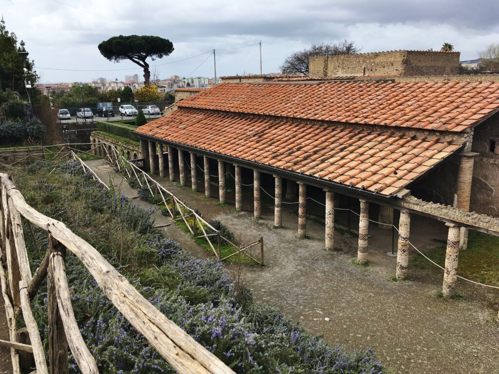 An excavated villa with columns and red roof tiles at Pompeii