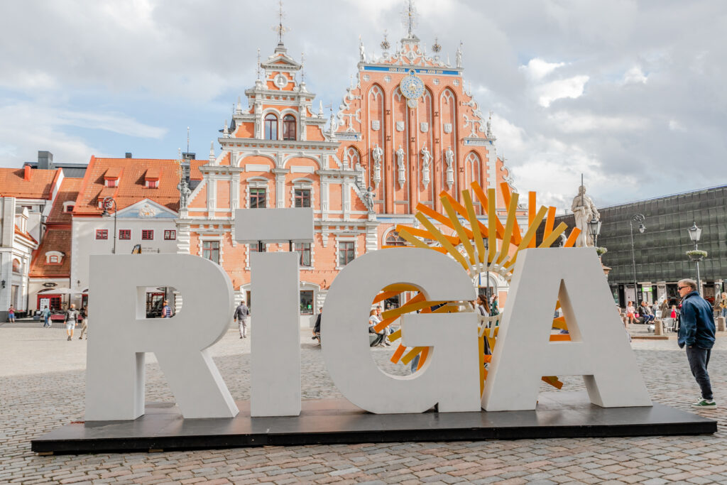 A large RIGA sign in front of a beautiful church, Latvia