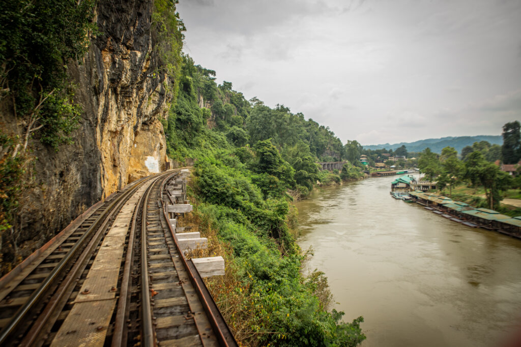 Part of the Death Railway tracks in between a steep cliff and a river, near Kanchanaburi, Thailand