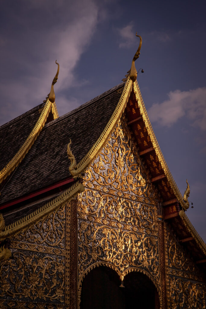 The pointed roof of a temple illuminated by the sun