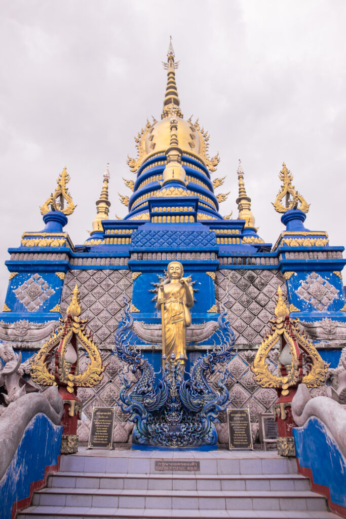 Looking up the steps of an ornate blue and gold temple