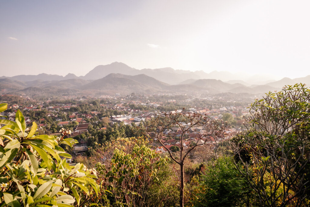 View over Luang Prabang from Phousi Hill, with evening light over the town and trees