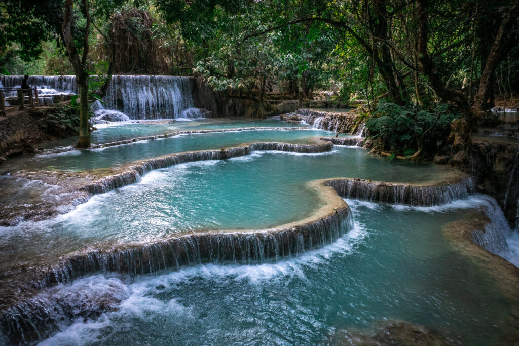 Natural terraces of falling turquoise water deep in the forest