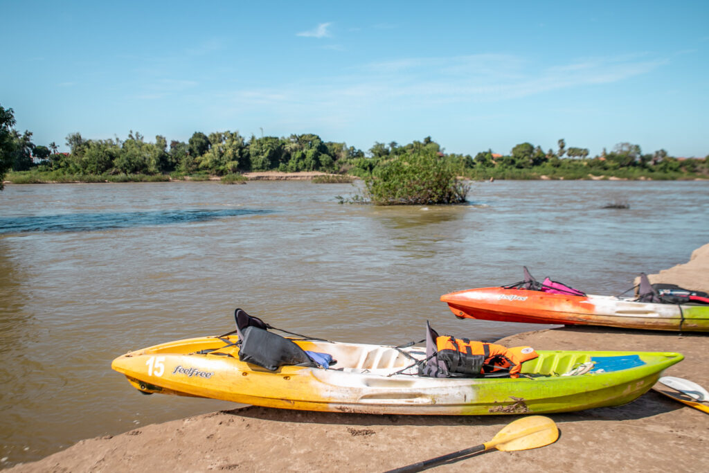 Kayaks sitting on a san bank on the Mekong river