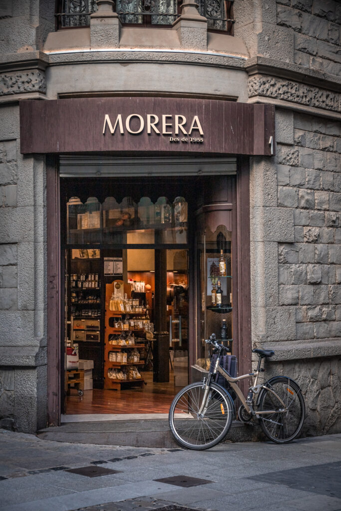 A bike leans against the doorway of a shop made of dark stone