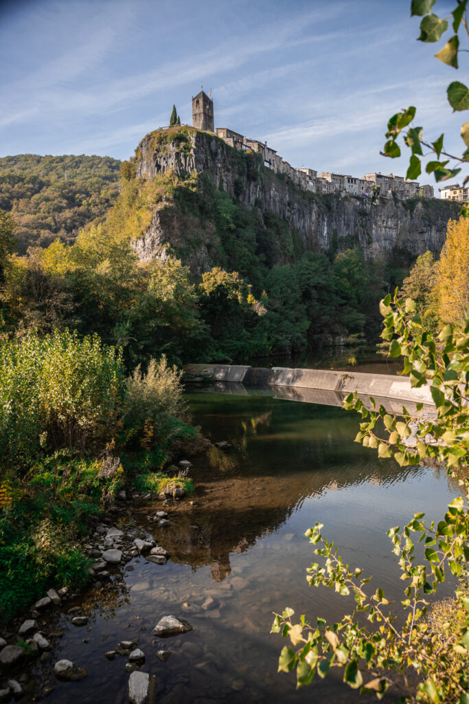 A town on top of a steep cliff, with a river running below